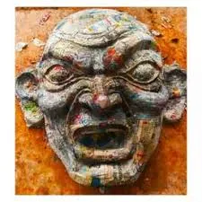 The face of a Narkasur being made by pasting Paper Mache on mud and clay mold